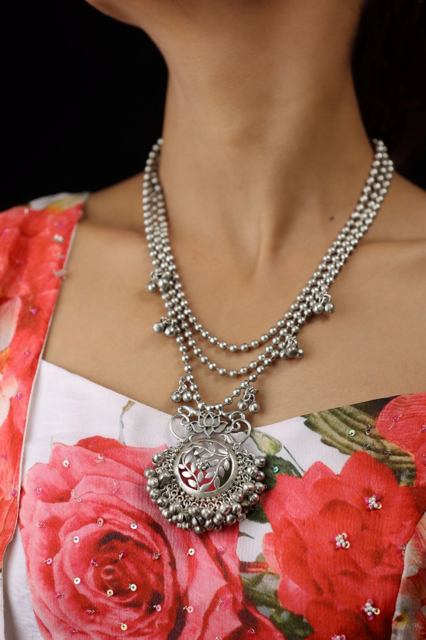 A multi-strand design with three delicate chains of small silver beads