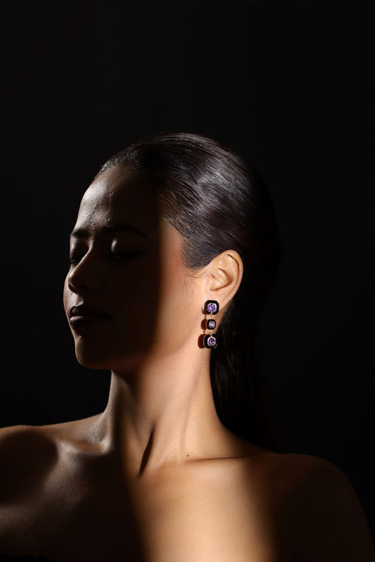 Dangling design earring with three bezel set square shaped gemstones