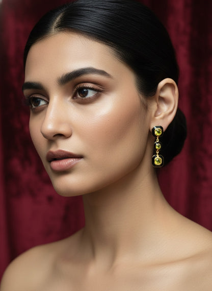 Dangling design earring with three bezel set square shaped gemstones