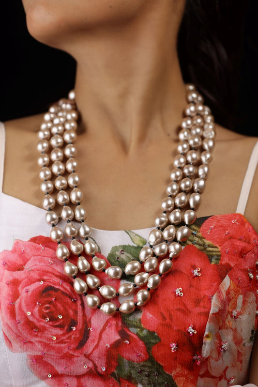 Vintage-style neckpiece with three strands of lustrous, baroque rose gold pearls