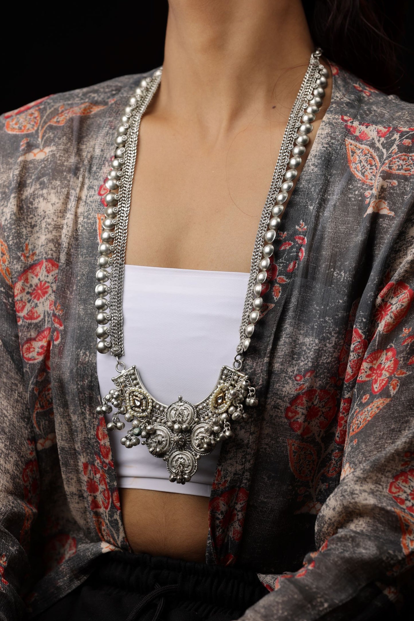 A long, dual-chain Neckpiece with a detailed ornate pendant